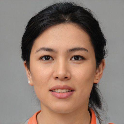 Joyful asian young-adult female with medium  brown hair and brown eyes