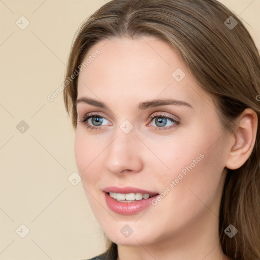 Joyful white young-adult female with long  brown hair and grey eyes