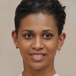 Joyful black young-adult female with short  brown hair and brown eyes