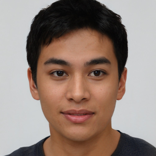 Joyful asian young-adult male with short  black hair and brown eyes