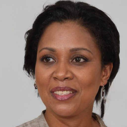 Joyful black adult female with medium  brown hair and brown eyes