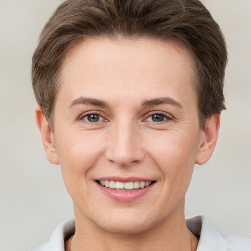 Joyful white young-adult female with short  brown hair and brown eyes