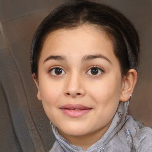 Joyful white child female with short  brown hair and brown eyes