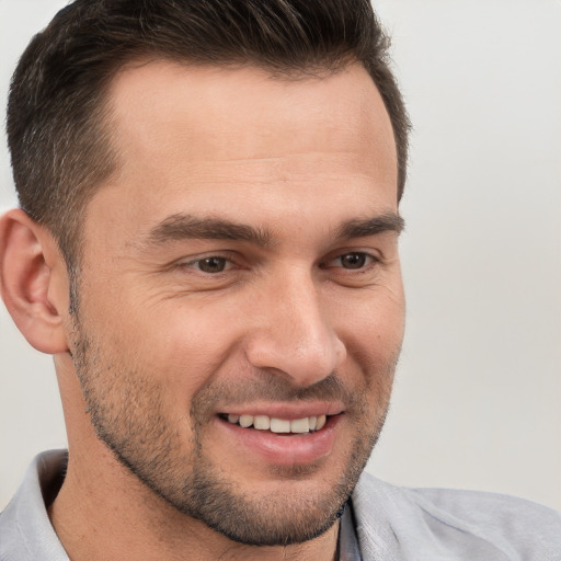 Joyful white young-adult male with short  brown hair and brown eyes