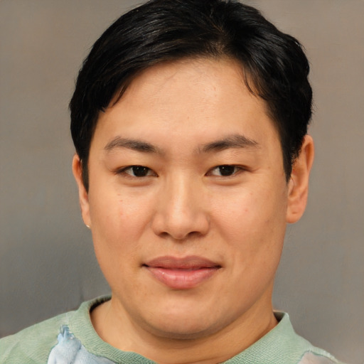 Joyful asian young-adult female with short  brown hair and brown eyes