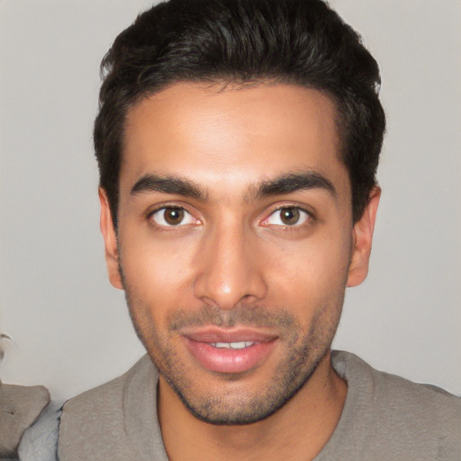 Joyful white young-adult male with short  black hair and brown eyes