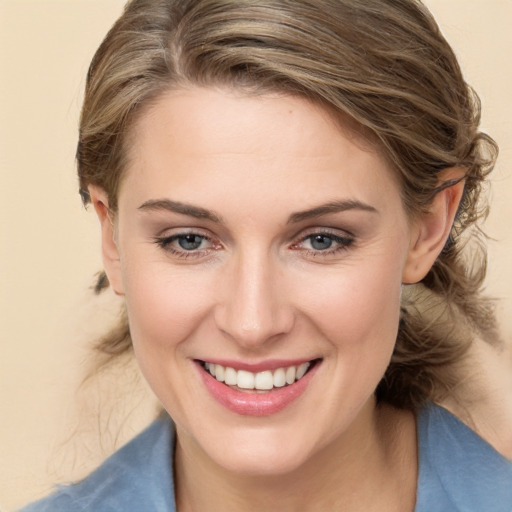 Joyful white young-adult female with medium  brown hair and blue eyes