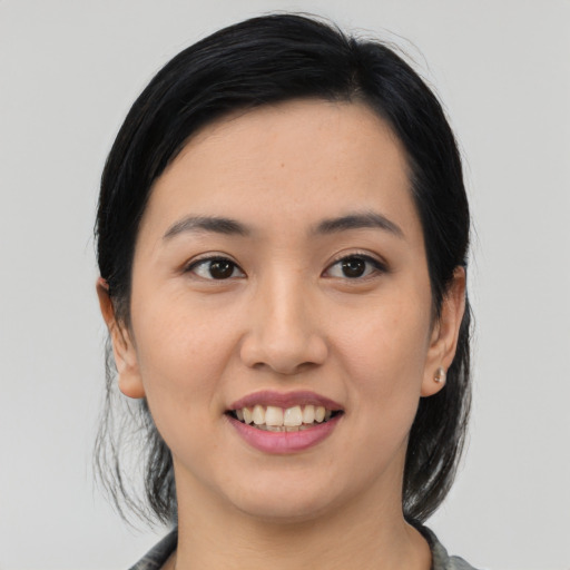 Joyful latino young-adult female with medium  black hair and brown eyes