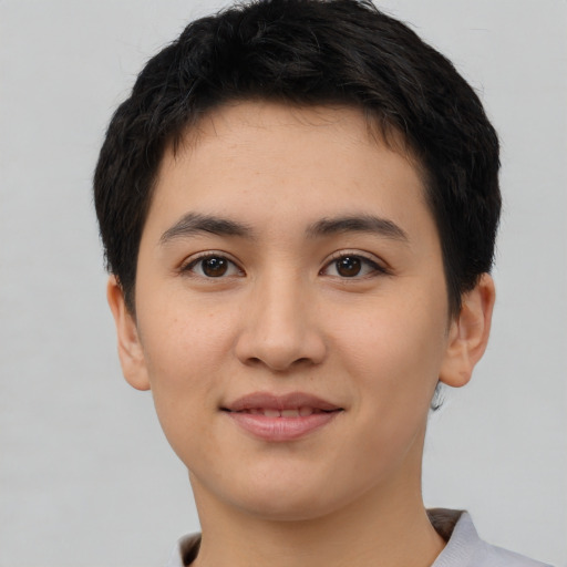Joyful asian young-adult female with short  black hair and brown eyes