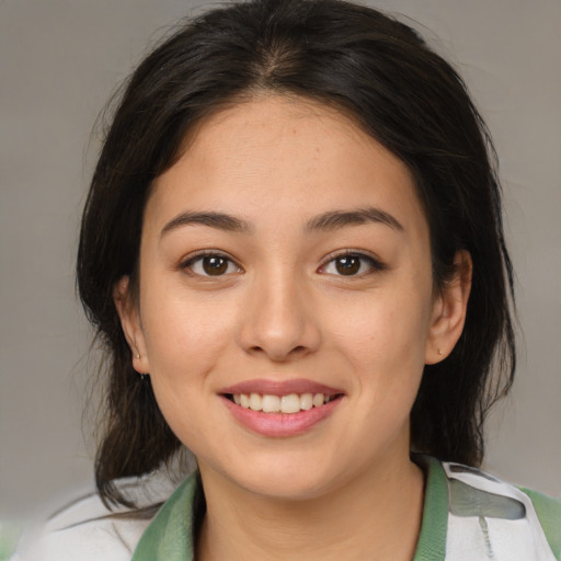 Joyful asian young-adult female with medium  brown hair and brown eyes