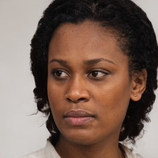 Neutral black young-adult female with medium  black hair and brown eyes
