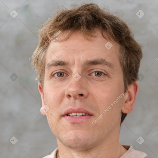 Joyful white adult male with short  brown hair and grey eyes