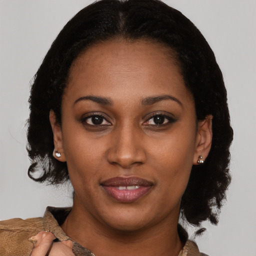 Joyful black young-adult female with medium  brown hair and brown eyes