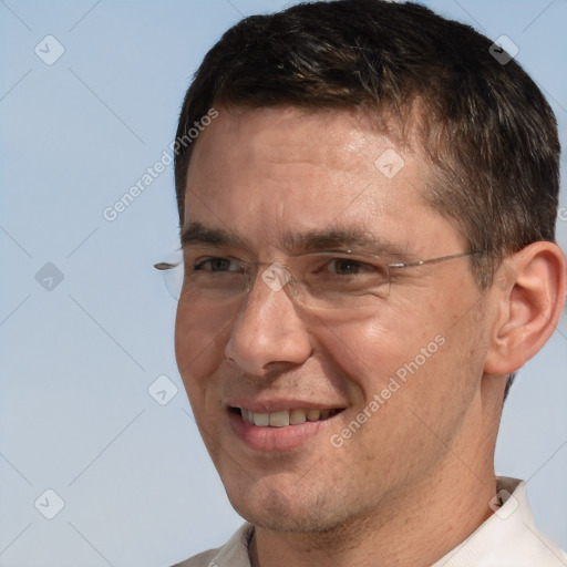 Joyful white adult male with short  brown hair and brown eyes