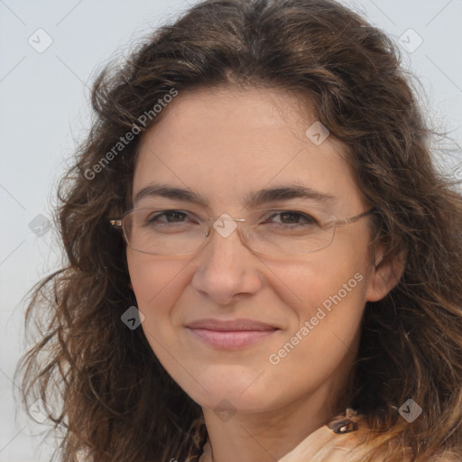Joyful white adult female with long  brown hair and brown eyes