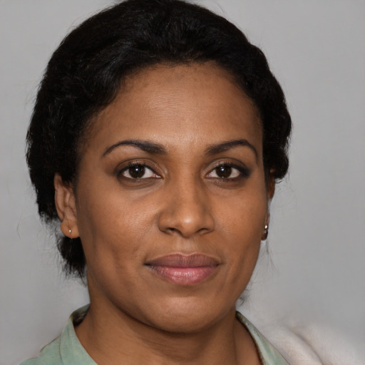 Joyful black young-adult female with medium  brown hair and brown eyes