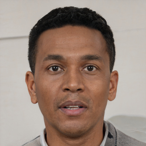 Neutral black young-adult male with short  black hair and brown eyes