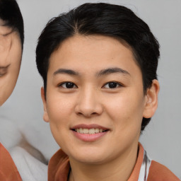 Joyful asian young-adult female with short  brown hair and brown eyes