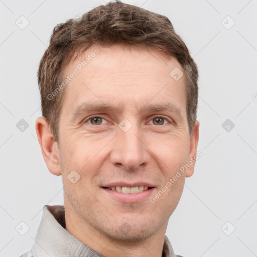 Joyful white adult male with short  brown hair and grey eyes