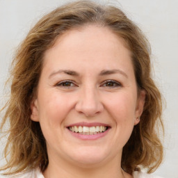 Joyful white adult female with medium  brown hair and brown eyes