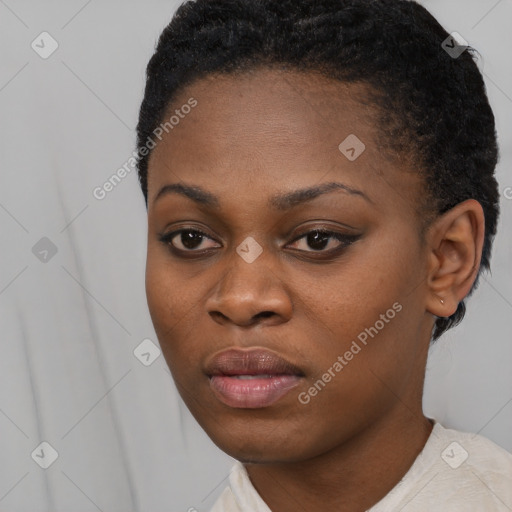 Joyful black young-adult female with short  black hair and brown eyes