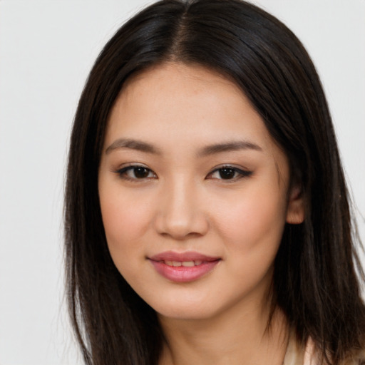 Joyful asian young-adult female with long  brown hair and brown eyes