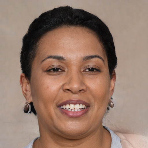 Joyful latino adult female with short  brown hair and brown eyes