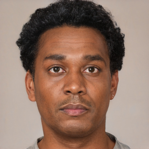 Neutral black adult male with short  black hair and brown eyes