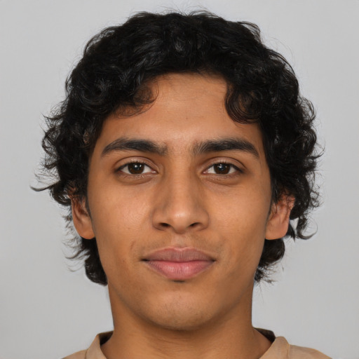 Joyful latino young-adult male with short  brown hair and brown eyes