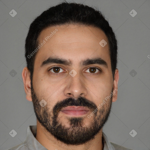 Joyful latino young-adult male with short  black hair and brown eyes