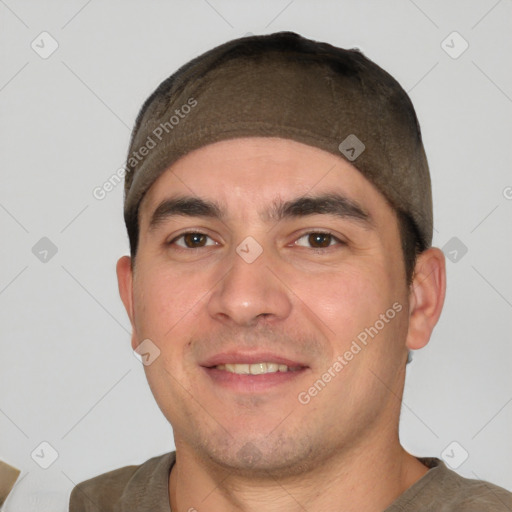 Joyful white young-adult male with short  black hair and brown eyes