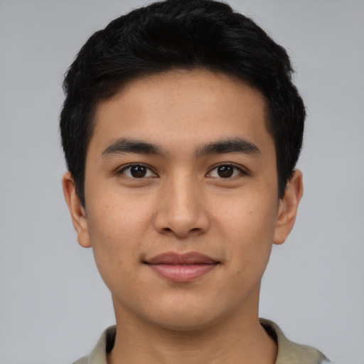 Joyful asian young-adult male with short  black hair and brown eyes