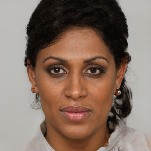 Joyful black adult female with short  brown hair and brown eyes