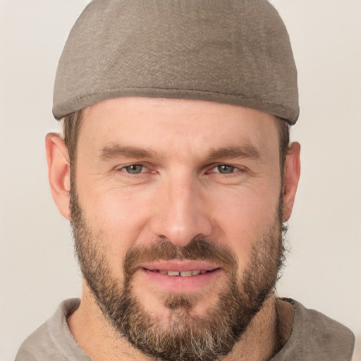 Joyful white adult male with short  brown hair and brown eyes