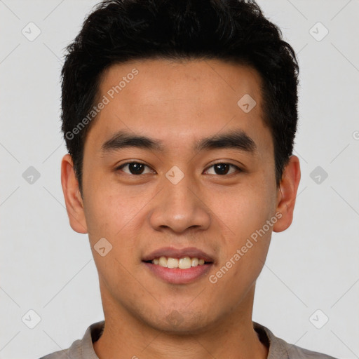 Joyful latino young-adult male with short  black hair and brown eyes