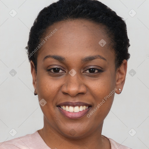 Joyful black young-adult female with short  black hair and brown eyes