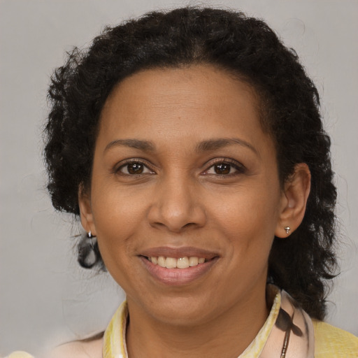 Joyful black adult female with short  brown hair and brown eyes