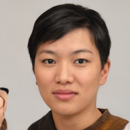 Joyful asian young-adult female with short  black hair and brown eyes