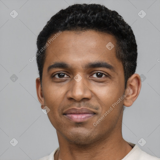 Joyful black young-adult male with short  black hair and brown eyes