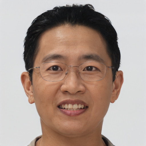 Joyful asian adult male with short  black hair and brown eyes