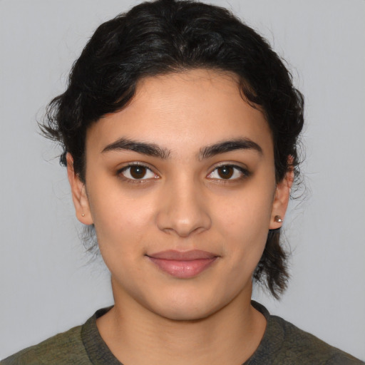 Joyful latino young-adult female with medium  black hair and brown eyes