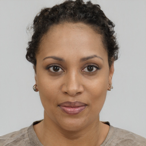 Joyful black young-adult female with short  brown hair and brown eyes