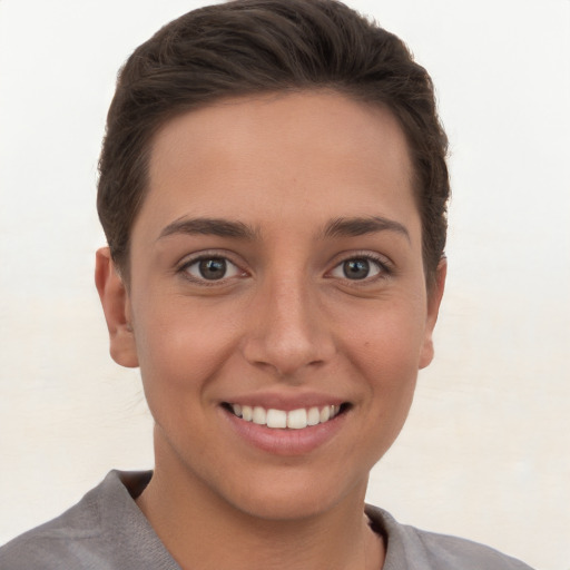 Joyful white young-adult female with short  brown hair and brown eyes