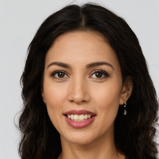 Joyful white young-adult female with long  brown hair and brown eyes