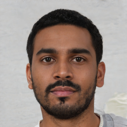 Neutral latino young-adult male with short  black hair and brown eyes