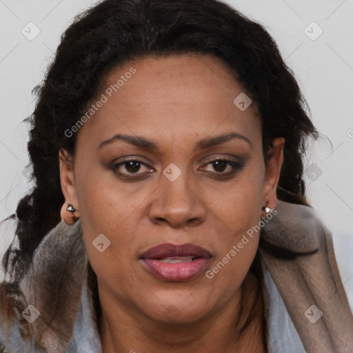 Joyful black adult female with long  brown hair and brown eyes