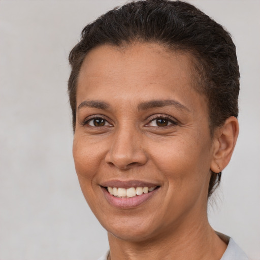 Joyful white adult female with short  brown hair and brown eyes