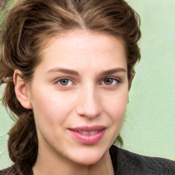 Joyful white young-adult female with medium  brown hair and green eyes