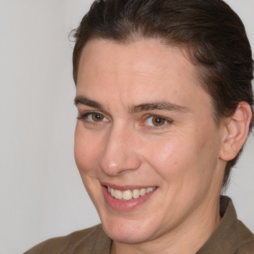 Joyful white adult female with short  brown hair and brown eyes