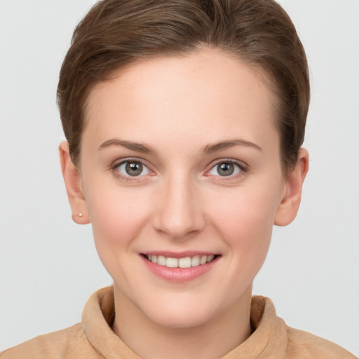 Joyful white young-adult female with short  brown hair and grey eyes